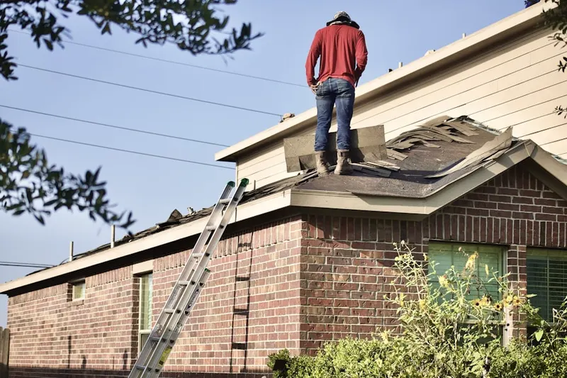 Professional roofer working on a residential roof in Norris Hills Court